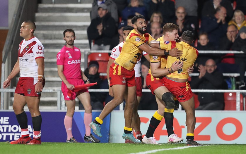 Dan Russell celebrates with fellow Kumuls Alex Johnston and Justin Olam at the Rugby League World Cup.