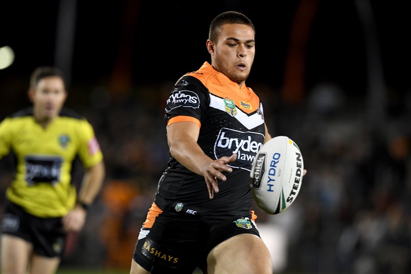 Wests Tigers five-eighth Tuimoala Lolohea gets a kick away.