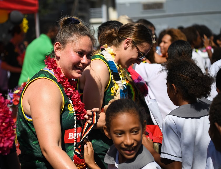 Members of the women's PM's XIII with students in Papua New Guinea.