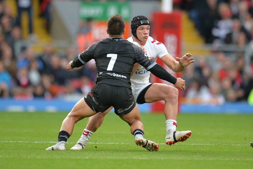 England fullback Jonny Lomax tries to get past New Zealand half Kodi Nikorima at Anfield.