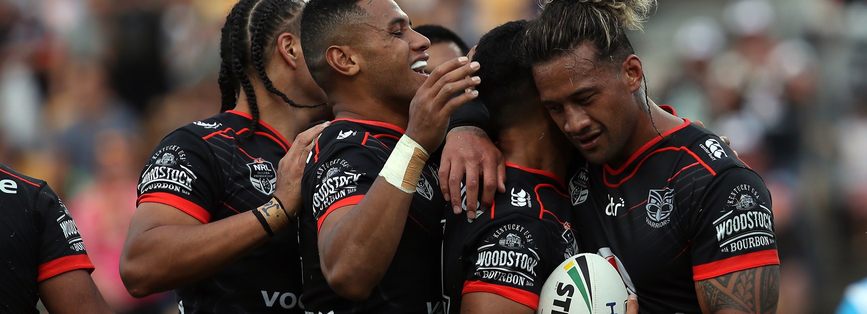 The Warriors celebrate a try against the Titans.