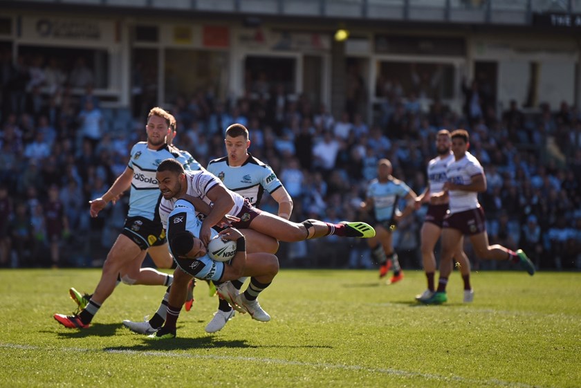 Valentine Holmes is tackled by Dylan Walker.