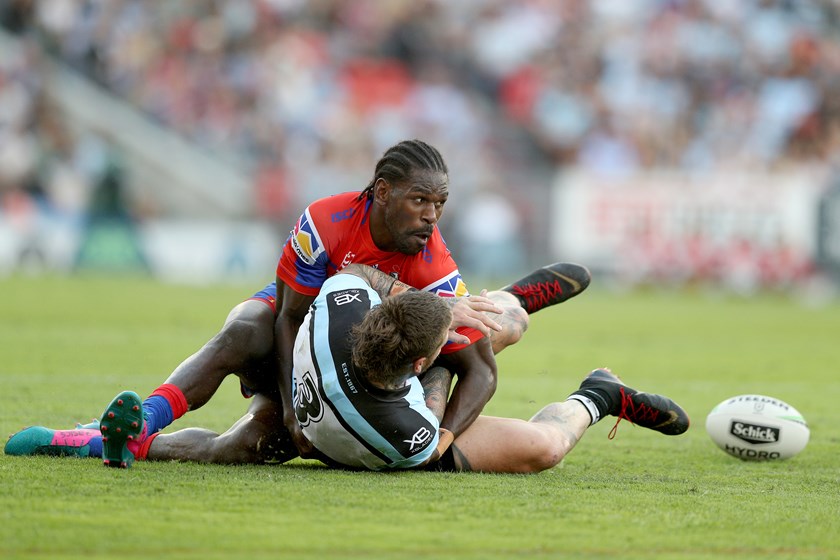 Knights winger Edrick Lee tackles Cronulla's Josh Dugan.