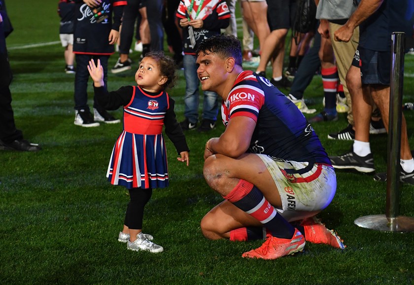 Latrell Mitchell with his daughter Inala after the 2019 grand final win over Canberra.