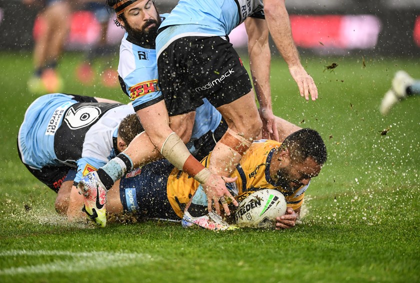 Eels forward Marata Niukore slides in the wet.