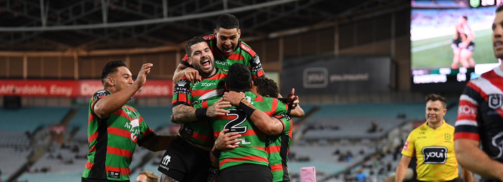 Alex Johnston is mobbed after his fifth try against the Roosters in round 20, 2020.