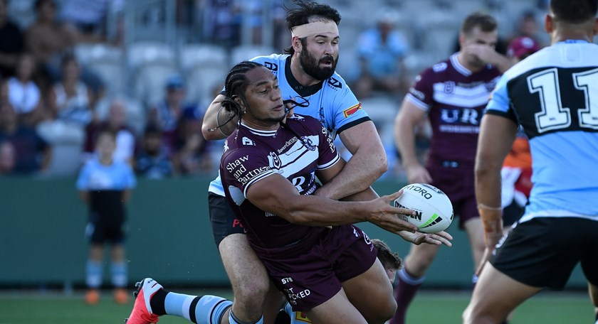 Martin Taupau slips a pass despite an Aaron Woods tackle.