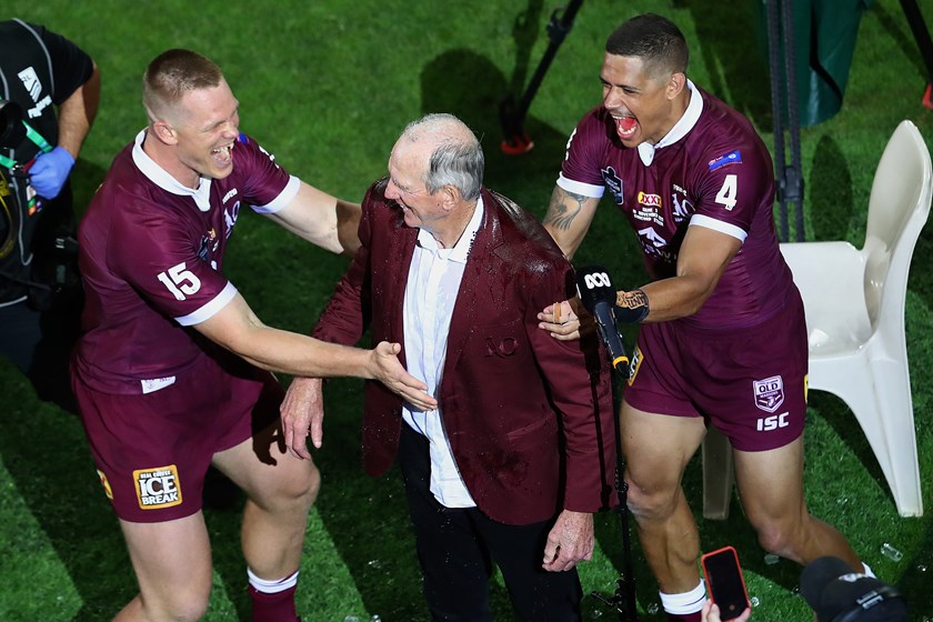 Dane Gagai and Lindsay Collins celebrate with Wayne Bennett after he guided Queensland to victory in the 2020 Origin series.